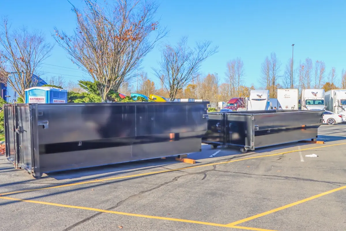 Professional dumpster rental service with roll-off container on residential driveway in Narragansett